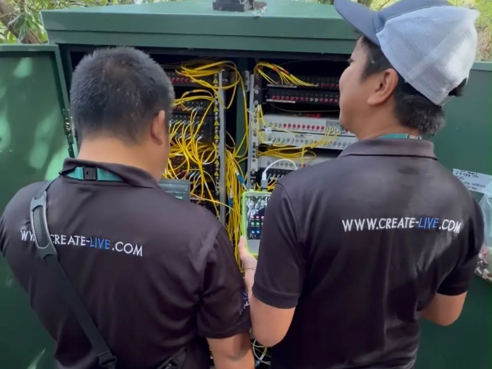Create Live engineers testing fibre patching in an outdoor network cabinet